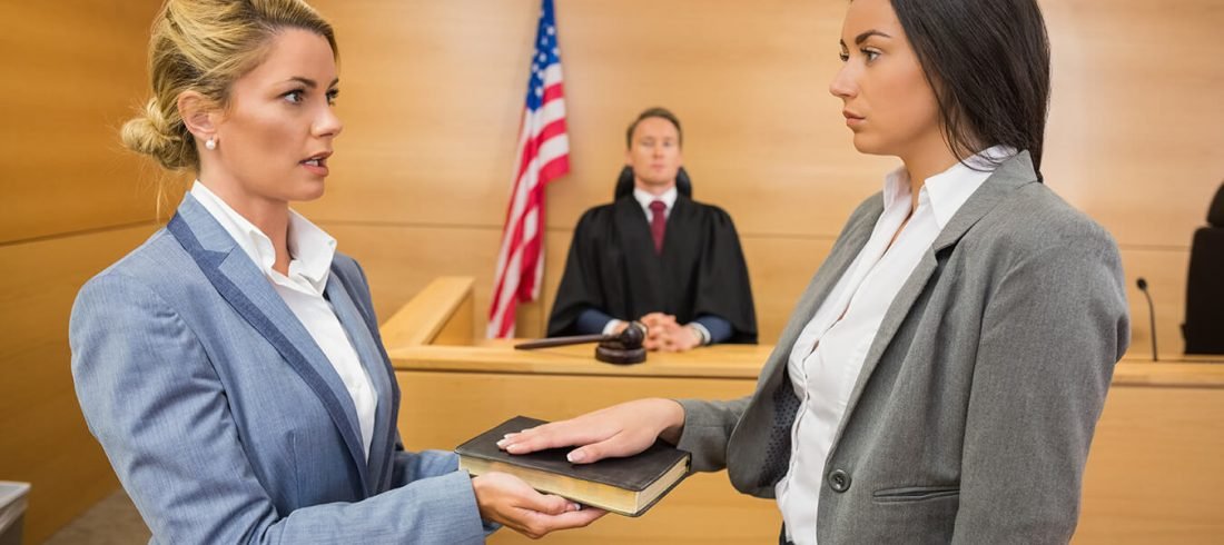 Articles Image of a witness being sworn in for testimony in front of a judge.