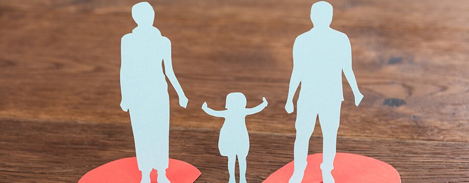 Child Support - paper images of an adult female and an adult male with a child in between them reaching for each adult's hand.